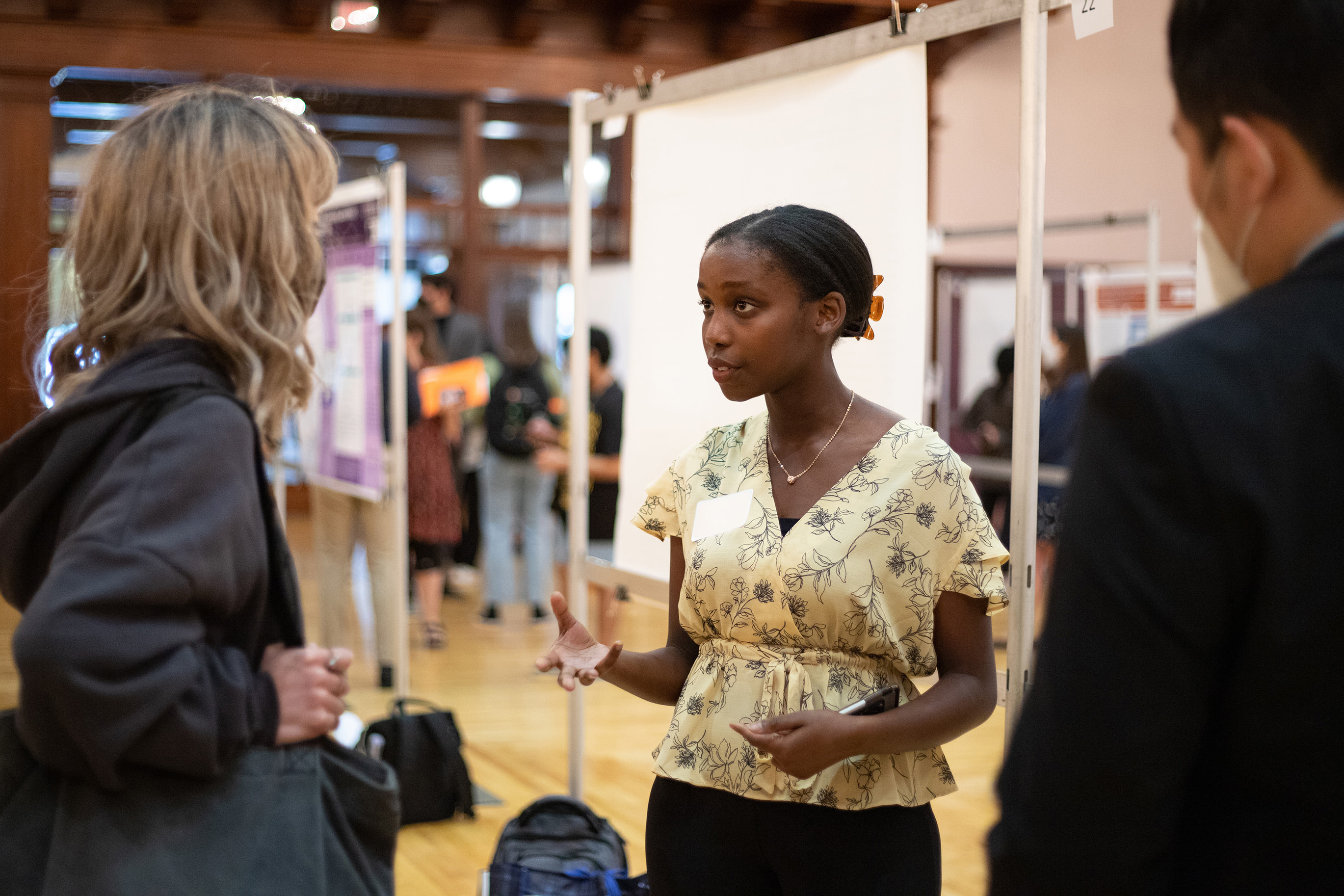 A student discusses their research at the 2022 Longhorn Research Poster Session